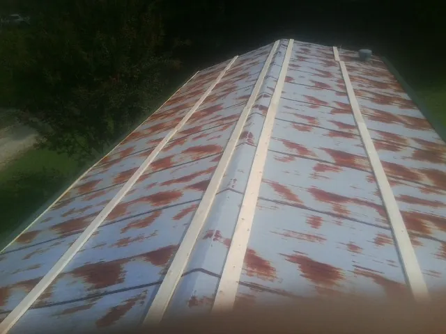 Rusted metal roof panels with new wood purlins before replacement — Storm Damage Roof Repair in Bird In Hand by Roofing Brothers