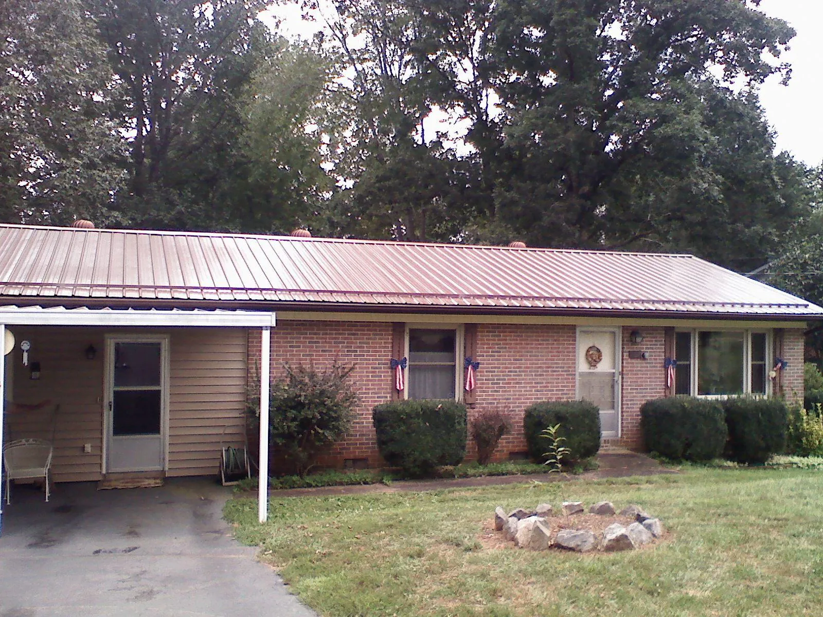 Bronze metal roof and carport on a brick ranch home — Roof Repair work by our crew in Bird In Hand